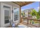 Enjoy outdoor living on the balcony with ferns, comfortable seating, and views of the neighborhood at 134 Everley Walk, Alpharetta, GA 30009
