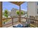 Cozy outdoor living on this balcony offers neighborhood views and hanging ferns for added privacy at 134 Everley Walk, Alpharetta, GA 30009