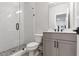 Modern bathroom featuring glass shower door, white subway tile, mosaic tile floor, and gray vanity at 134 Everley Walk, Alpharetta, GA 30009