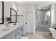 Modern bathroom with double vanity, a glass-enclosed shower, and a soaking tub at 134 Everley Walk, Alpharetta, GA 30009