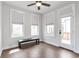 Well-lit bedroom with hardwood floors, a ceiling fan, and a walkout balcony at 134 Everley Walk, Alpharetta, GA 30009