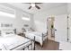 Stylishly decorated bedroom with hardwood floors, a ceiling fan, and two twin beds at 134 Everley Walk, Alpharetta, GA 30009