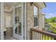 Bedroom view from balcony featuring brick detail, window, and outdoor scenery at 134 Everley Walk, Alpharetta, GA 30009