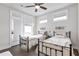 Bright bedroom featuring two twin beds, modern ceiling fan, and natural light at 134 Everley Walk, Alpharetta, GA 30009