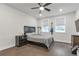 Comfortable bedroom with hardwood floors, a ceiling fan, and a mounted TV at 134 Everley Walk, Alpharetta, GA 30009