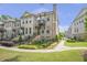 Charming brick townhome with a front yard enclosed by a black fence and steps leading to the front door at 134 Everley Walk, Alpharetta, GA 30009
