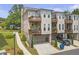 Beautiful townhome featuring a private balcony, attached two-car garage, and neutral-colored exterior at 134 Everley Walk, Alpharetta, GA 30009