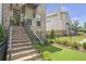 Brick stairs leading to a front entrance with manicured landscaping and decorative shrubbery at 134 Everley Walk, Alpharetta, GA 30009