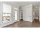 Hallway with hardwood floors, white walls, and doors leading to other rooms at 134 Everley Walk, Alpharetta, GA 30009