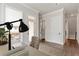 Home office with desk, chair, rug, hardwood floors, and door to the outside at 134 Everley Walk, Alpharetta, GA 30009