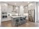 Well-lit kitchen with stainless steel appliances, light grey cabinets, and hardwood floors at 134 Everley Walk, Alpharetta, GA 30009