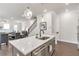 Open-concept kitchen with stainless steel appliances, quartz countertops, and eat-in island at 134 Everley Walk, Alpharetta, GA 30009