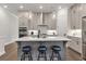 Kitchen with gray cabinets, quartz countertops, stainless steel appliances, and eat-in island at 134 Everley Walk, Alpharetta, GA 30009