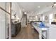 Open-concept living space leading to the kitchen with hardwood floors and modern finishes at 134 Everley Walk, Alpharetta, GA 30009