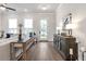 Living room with hardwood floors, large windows, white walls, and stylish decor at 134 Everley Walk, Alpharetta, GA 30009