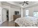 This primary bedroom boasts a ceiling fan, tray ceiling, an ensuite bathroom, and balcony access at 134 Everley Walk, Alpharetta, GA 30009