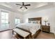 Spacious main bedroom features a tray ceiling, fan, and a door to the balcony, providing access to outdoor space at 134 Everley Walk, Alpharetta, GA 30009