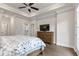 Spacious primary bedroom features a ceiling fan, tray ceiling, ensuite bathroom, and balcony access at 134 Everley Walk, Alpharetta, GA 30009