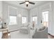 Bright sitting room with two armchairs, two windows, and neutral decor at 134 Everley Walk, Alpharetta, GA 30009