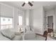 Sitting room with two armchairs, hardwood floors, and plenty of natural light at 134 Everley Walk, Alpharetta, GA 30009