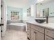 Bright bathroom with a soaking tub, vessel sink, and custom vanity at 1698 Bennett Dr, Mcdonough, GA 30253