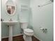 Powder room features a pedestal sink, oval mirror, and modern fixtures at 1698 Bennett Dr, Mcdonough, GA 30253