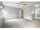 This light and bright carpeted bedroom has a ceiling fan and attached bathroom at 1698 Bennett Dr, Mcdonough, GA 30253