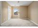 Bedroom featuring a ceiling fan, plush carpet, and a large window with neighborhood views at 1698 Bennett Dr, Mcdonough, GA 30253