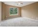 This bedroom features plush carpet, a large window, and a neutral color scheme at 1698 Bennett Dr, Mcdonough, GA 30253