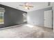 This large bedroom features neutral walls, carpet, two windows and ceiling fan at 1698 Bennett Dr, Mcdonough, GA 30253