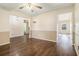 Neutral-toned dining room with stylish wood floors, wainscoting, and ample natural light through window at 1698 Bennett Dr, Mcdonough, GA 30253