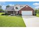 Charming two-story brick home with a well-manicured lawn and a two-car garage on a sunny day at 1698 Bennett Dr, Mcdonough, GA 30253