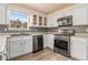 Modern kitchen with white cabinetry, stainless steel appliances, and a window overlooking the backyard at 1698 Bennett Dr, Mcdonough, GA 30253