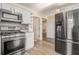 This remodeled kitchen features stainless steel appliances, gray backsplash and newly refinished cabinets at 1698 Bennett Dr, Mcdonough, GA 30253