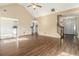 Open living room with vaulted ceiling, hardwood floors, leading to kitchen, and a staircase, perfect for entertaining at 1698 Bennett Dr, Mcdonough, GA 30253