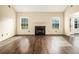 Spacious living room featuring hardwood floors, a fireplace, and plenty of natural light at 1698 Bennett Dr, Mcdonough, GA 30253