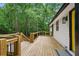 Spacious wooden deck, perfect for entertaining, overlooking a private, wooded backyard and a white house at 3713 Brigantine Ct, Acworth, GA 30102