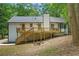 Exterior of home featuring a deck overlooking a wooded backyard. Perfect for outdoor living and enjoying nature at 3713 Brigantine Ct, Acworth, GA 30102