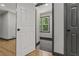 Basement entrance with modern interior, featuring wood floors, white trim, and a window for natural light at 3713 Brigantine Ct, Acworth, GA 30102