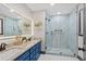 Modern bathroom features a double vanity with granite counters, and a glass shower with decorative tile at 3713 Brigantine Ct, Acworth, GA 30102