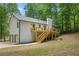 Charming home featuring a wooden deck and stairs, surrounded by lush greenery at 3713 Brigantine Ct, Acworth, GA 30102