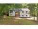 Charming two-story home with a white exterior, black trim, and a bright yellow front door at 3713 Brigantine Ct, Acworth, GA 30102