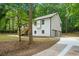 Two-story home with an attached garage and inviting deck, surrounded by trees and lawn at 3713 Brigantine Ct, Acworth, GA 30102