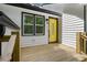 Inviting front porch with wooden decking and a bright yellow door at 3713 Brigantine Ct, Acworth, GA 30102