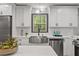 Well-lit kitchen with white cabinets, stainless steel appliances, and stylish backsplash at 3713 Brigantine Ct, Acworth, GA 30102