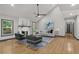 Bright living room with vaulted ceiling, modern fan, fireplace, and hardwood floors at 3713 Brigantine Ct, Acworth, GA 30102