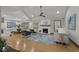 Open-concept living room with hardwood floors, a fireplace, and modern furnishings at 3713 Brigantine Ct, Acworth, GA 30102