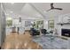 Open-concept living room with hardwood floors, a fireplace, and a view to the kitchen at 3713 Brigantine Ct, Acworth, GA 30102