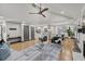 Open-concept living room with fireplace, hardwood floors, modern decor, and vaulted ceilings at 3713 Brigantine Ct, Acworth, GA 30102