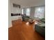 Bright living room featuring hardwood floors, comfortable seating, and large windows offering city views at 57 Forsyth Nw St # 11B, Atlanta, GA 30303